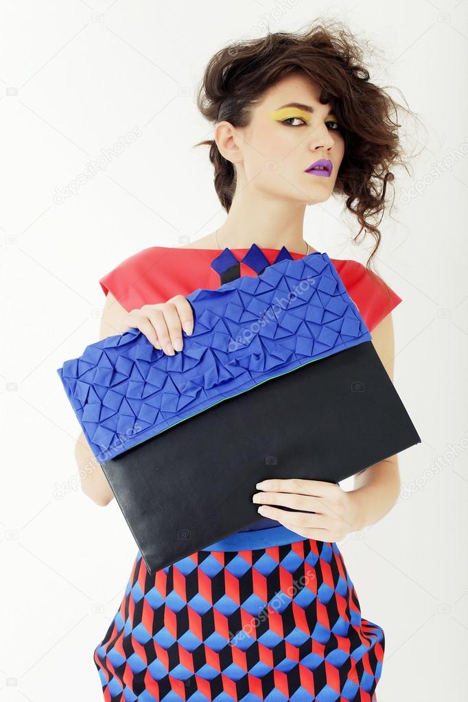 beautiful woman in an colorful dress with a clutch
