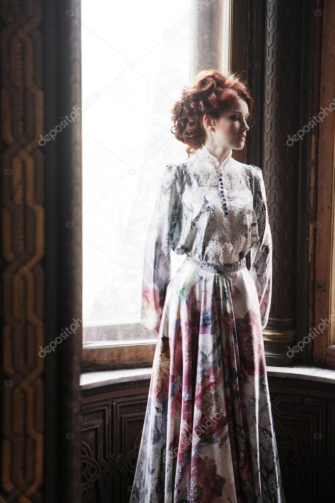 woman in pink dress posing in luxury palace