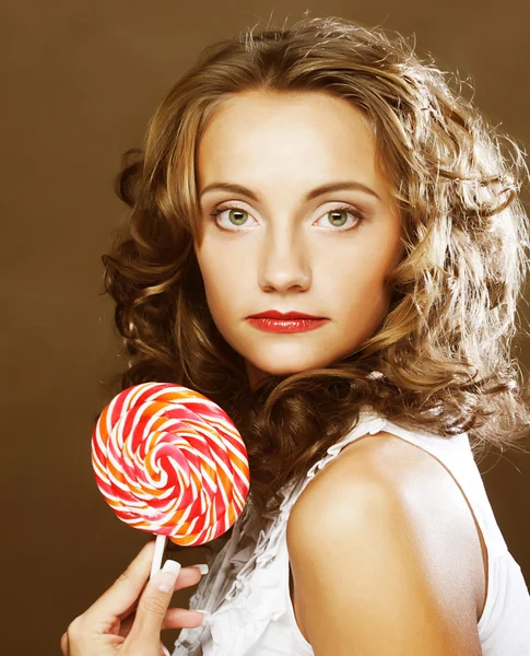 Curly  girl with a lollipop in her hand — Stock Photo, Image