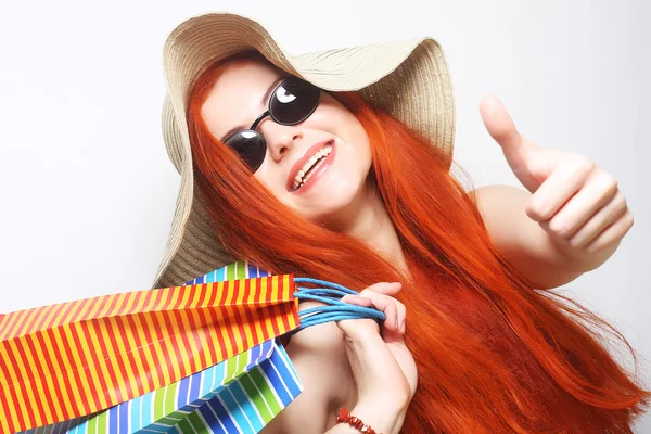 Ruiva mulher de compras usando óculos de sol e chapéu — Fotografia de Stock