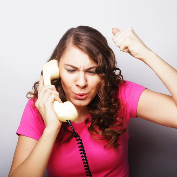 Furious girl with vintage phone — Stock Photo, Image