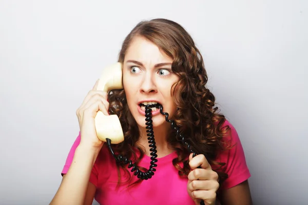 Furious girl with vintage phone — Stock Photo, Image
