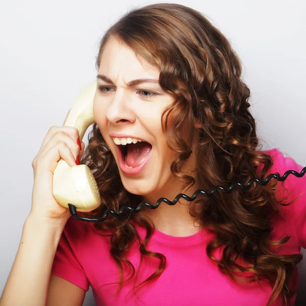 Furious girl with vintage phone Royalty Free Stock Images