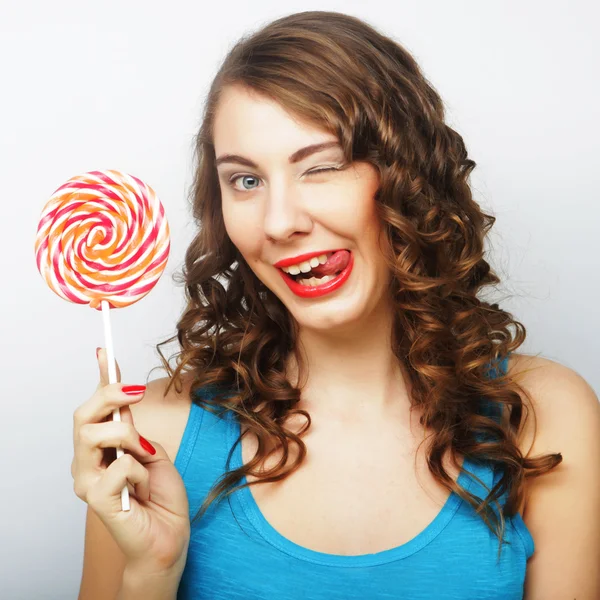 Funny curly woman  holding big lollipop. — Stock Photo, Image