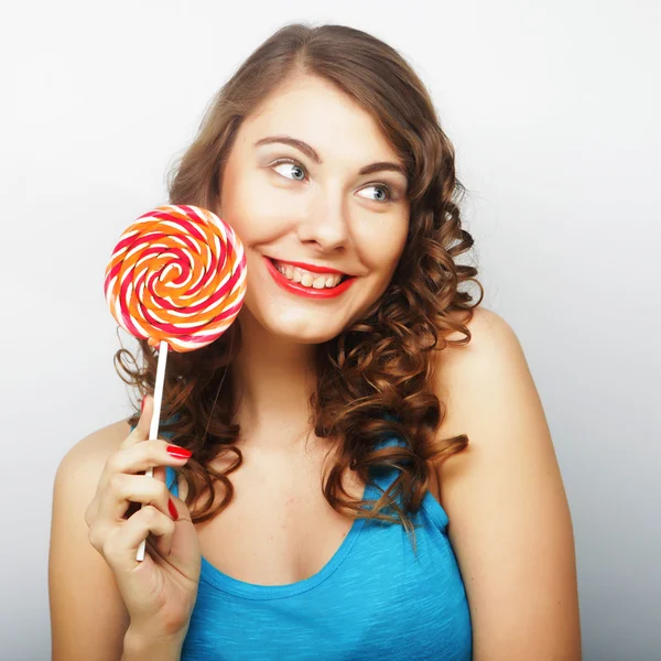 Funny curly woman  holding big lollipop. — Stock Photo, Image