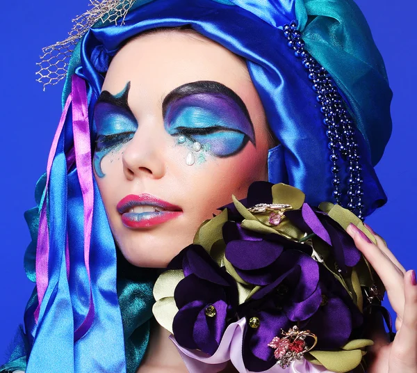 Woman with creative make up holding a bouquet of jewelry — Stock Photo, Image