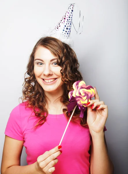 Funny curly woman  holding big lollipop. — Stock Photo, Image