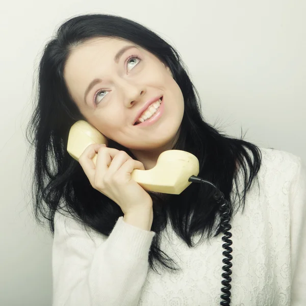 Young happy woman with vintage phone — Stock Photo, Image