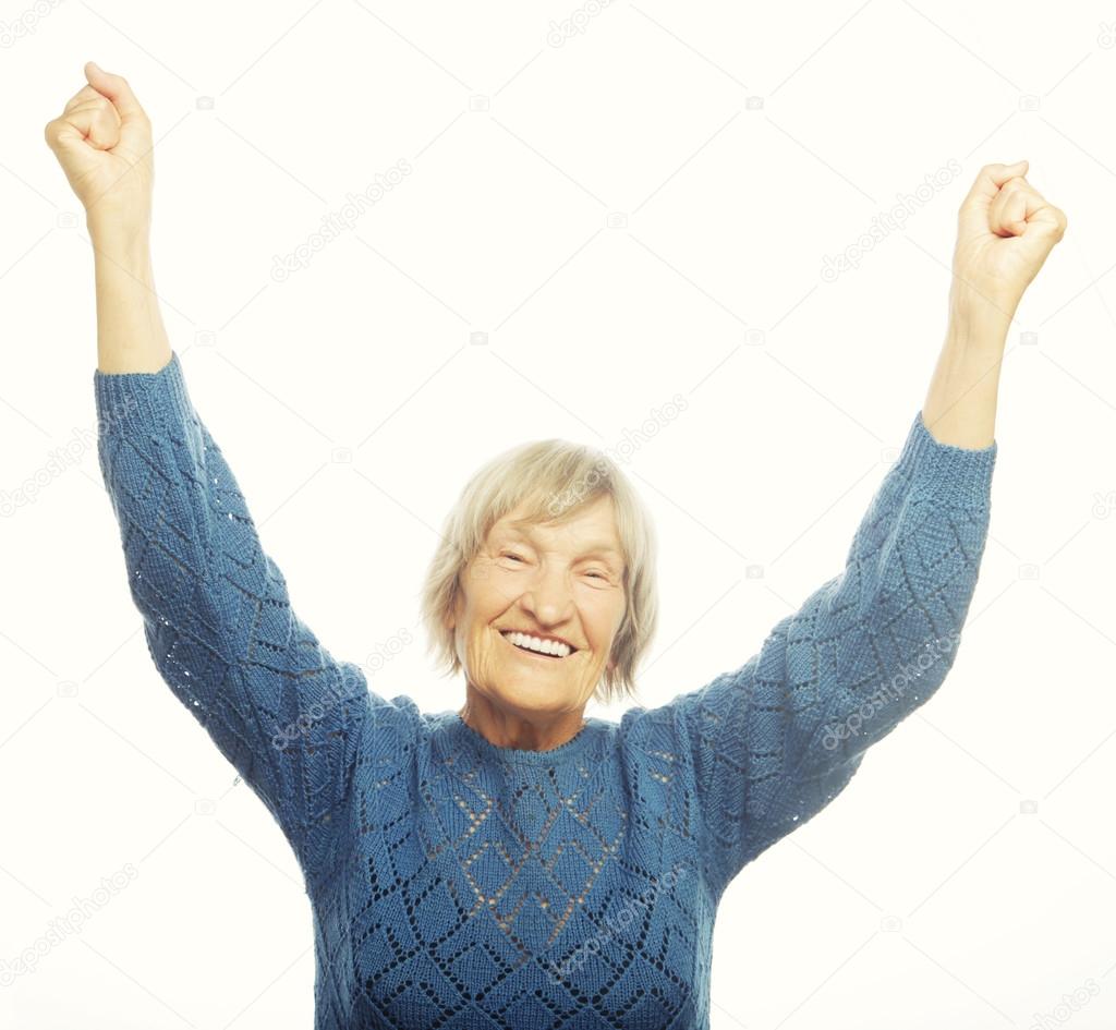 cheerful senior woman gesturing victory