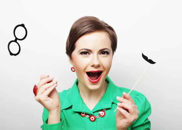 Woman holding mustache and glasses on a stick. — Stock Photo, Image