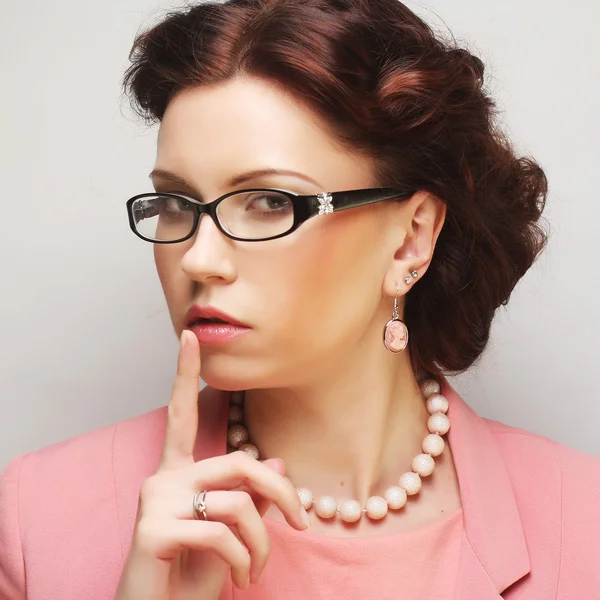 Young businesswoman in pink wearing glasses. — Stock Photo, Image