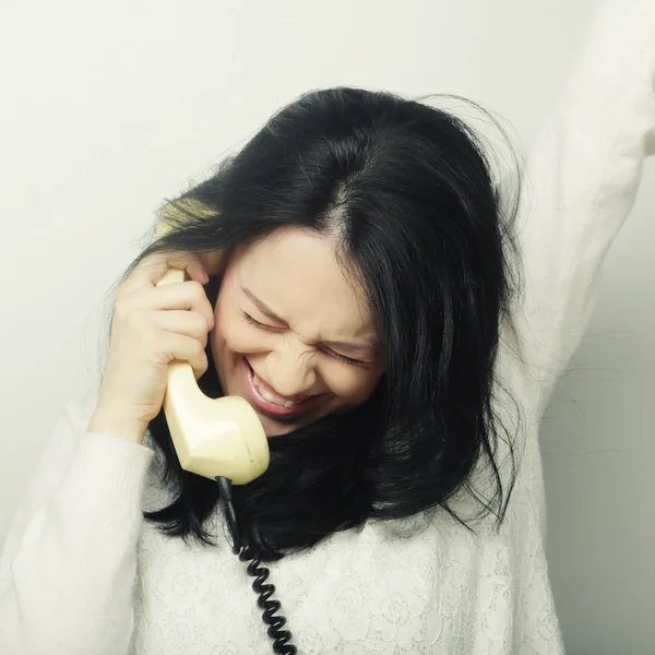 Furious girl with vintage phone — Stock Photo, Image