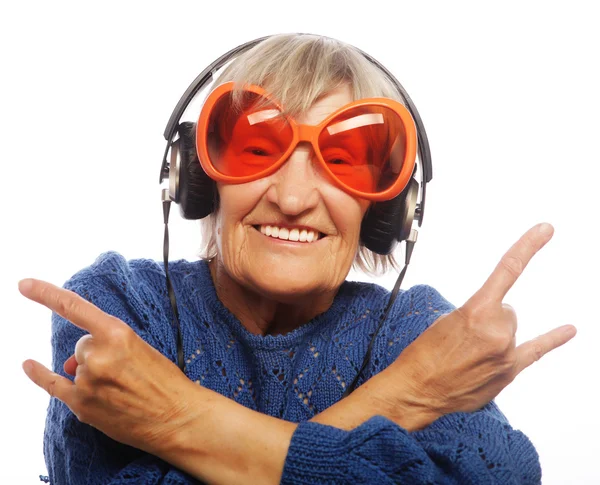 Funny old lady listening music — Stock Photo, Image