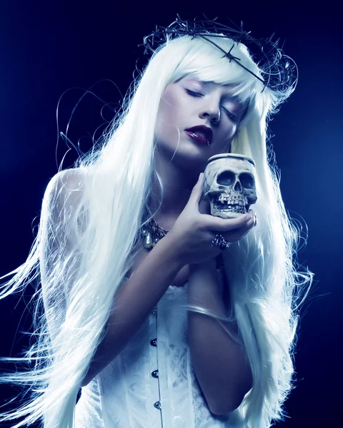 Angelic long hair woman with skull — Stock Photo, Image