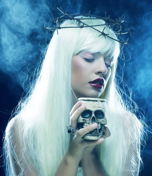 Angelic long hair woman with skull — Stock Photo, Image