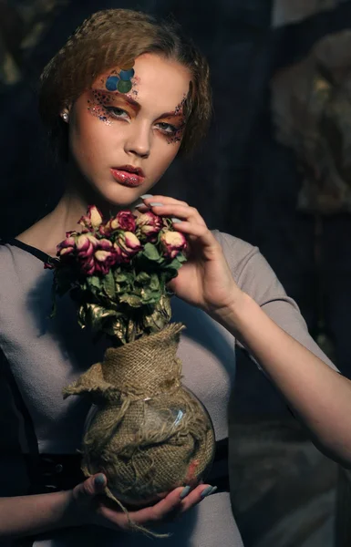 Beautiful girl with dry roses — Stock Photo, Image