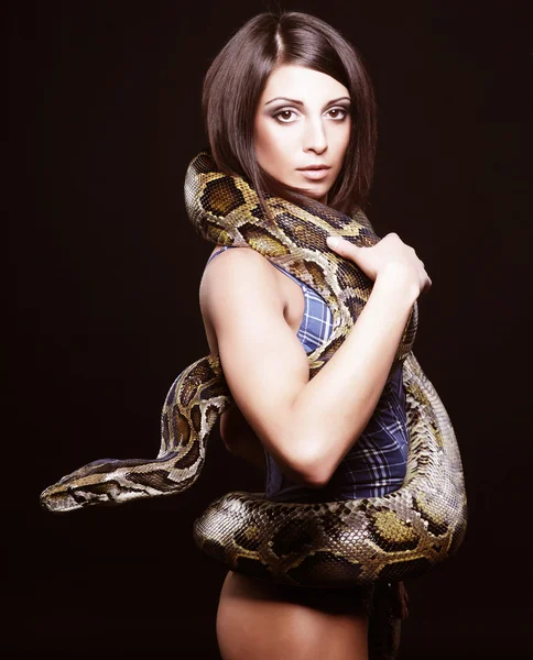 Sexy brunette holding python — Stock Photo, Image