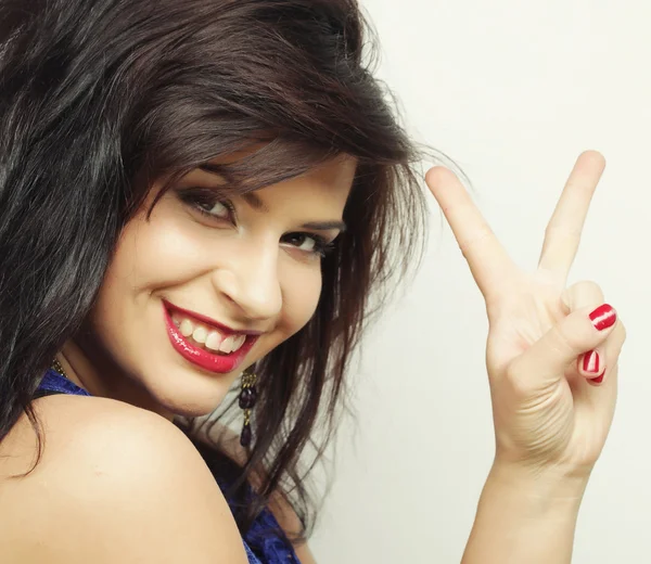 Young woman showing two fingers — Stock Photo, Image