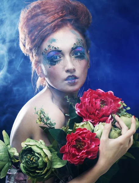 Beautiful redhair woman  holding flowers — Stock Photo, Image