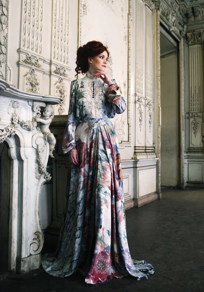 Woman  posing next to the fireplace — Stock Photo, Image