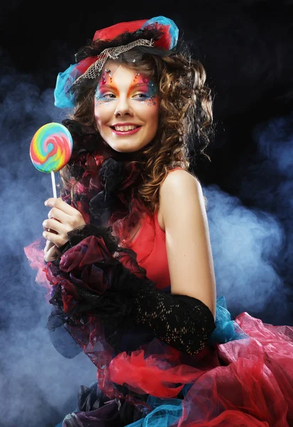 Girl with with creative make-up holds lollipop. — Stock Photo, Image