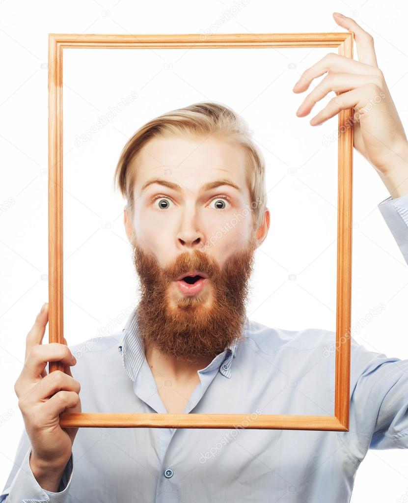 Young man holding picture frame