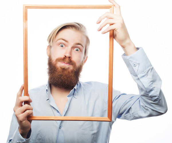 Young man holding picture frame