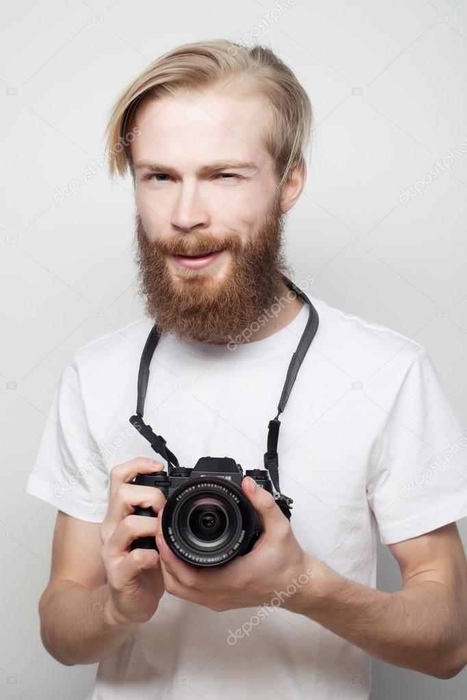 bearded man with a digital camera