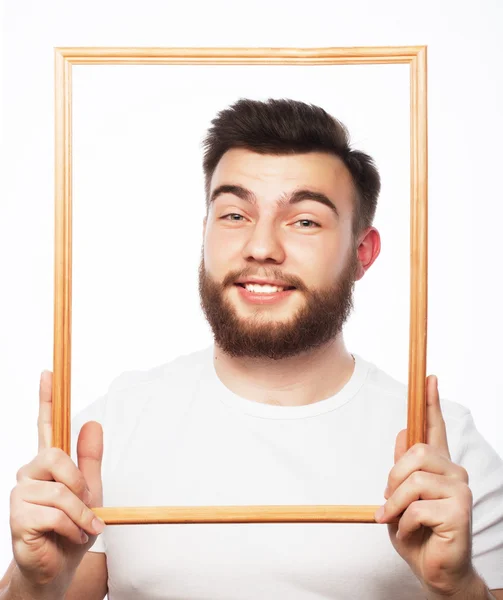 Young man holding picture frame — Stock Photo, Image