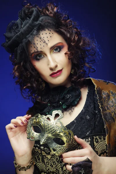 Curly woman with mask. Carnaval visage. — Stock Photo, Image