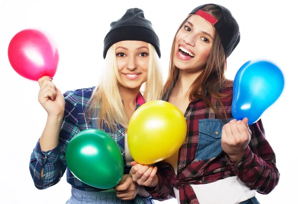 Hipster girls smiling and holding colored balloons — Stock Photo, Image
