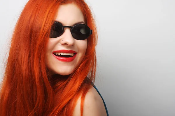 Young surprised woman wearing sunglasses. Stock Picture