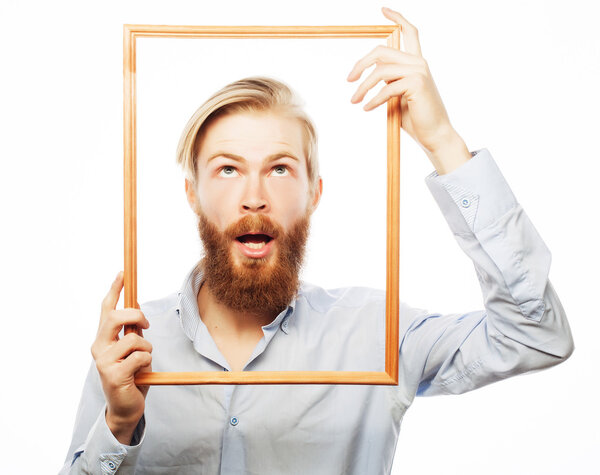 Young man holding picture frame