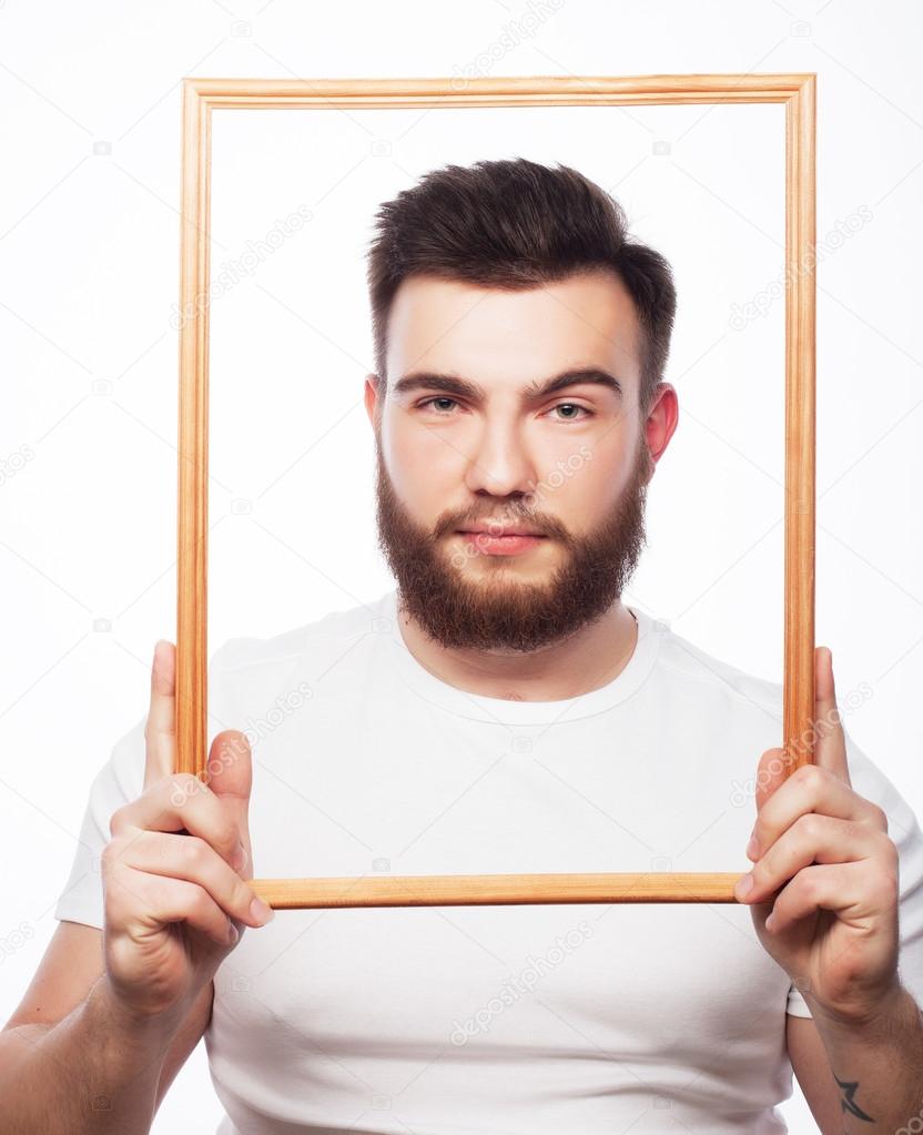 Young man holding picture frame