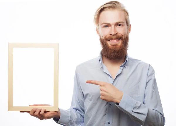 Bearded  man holding a picture frame — Stock Photo, Image