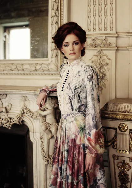 Woman  posing next to the fireplace — Stock Photo, Image