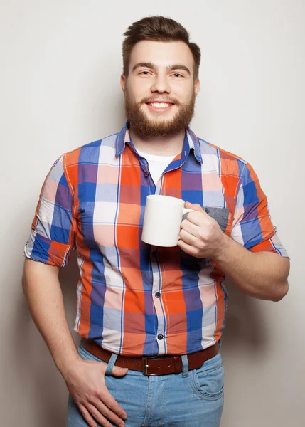Young bearded man with a cup of coffee — Stock Photo, Image