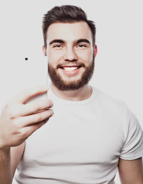 Young bearded man with mobile phone — Stock Photo, Image