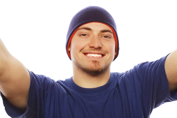 Young man holding camera and making selfie — Stock Photo, Image