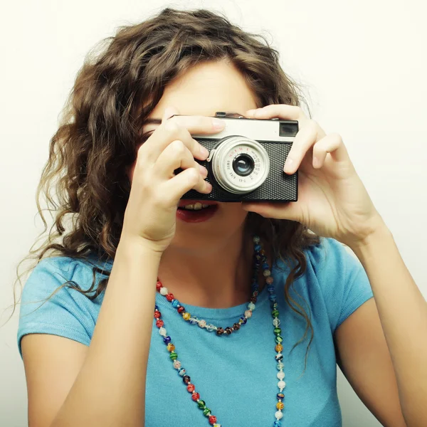 Young curly woman with vintage camera — Stock Photo, Image