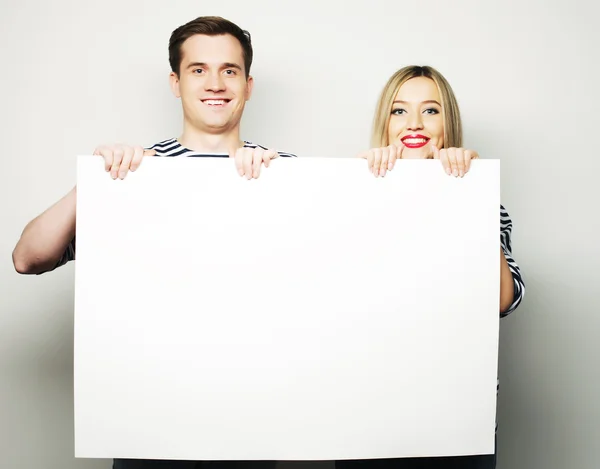 Couple holding a banner — Stock Photo, Image