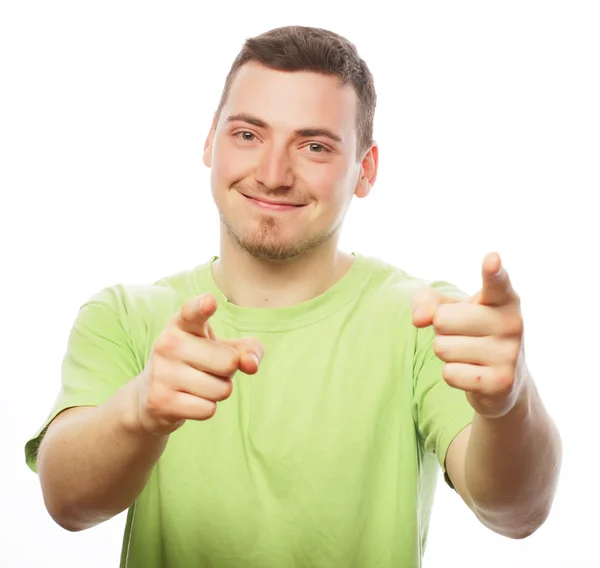 Young smiling happy man shows something — Stock Photo, Image