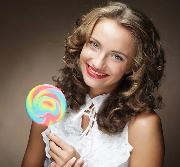 Young woman with colorful lollipop — Stock Photo, Image