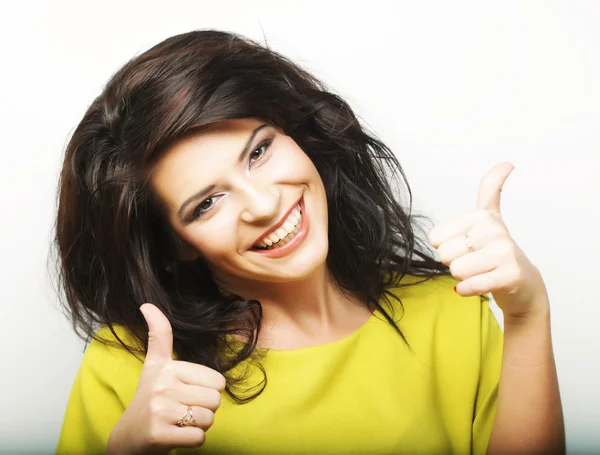 Young woman showing thumbs up gesture — Stock Photo, Image