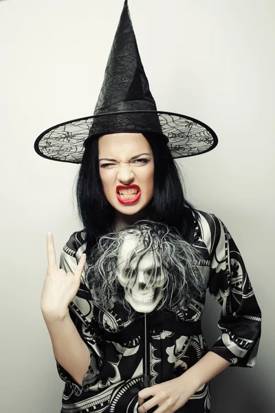 Funny Witch with skull. Studio shot. — Stock Photo, Image