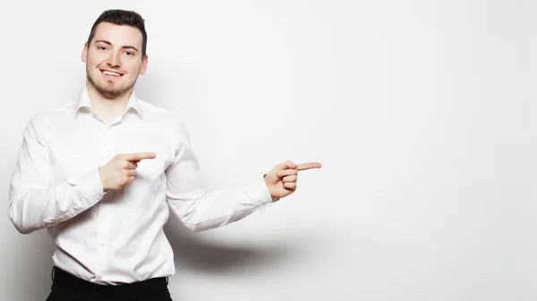 Business man points with fingers in the right side — Stock Photo, Image