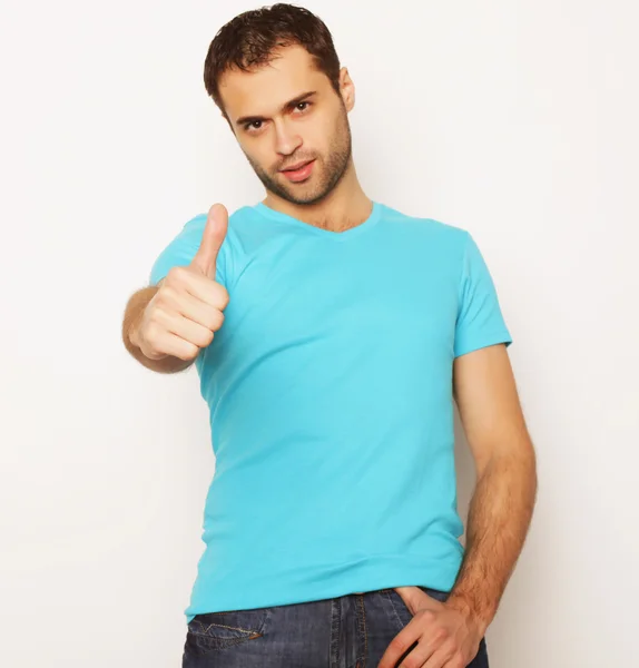 Happy young man showing thumbs up — Stock Photo, Image