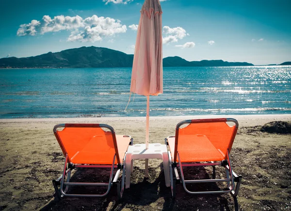 Tumbonas con sombrillas en la hermosa playa —  Fotos de Stock