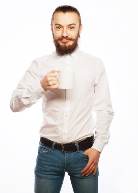 Genç adam bir fincan kahve içiyor. 