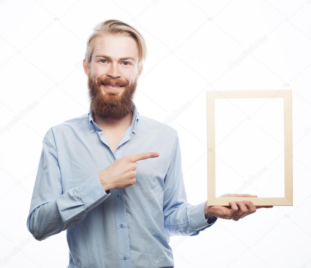 bearded  man holding a picture frame